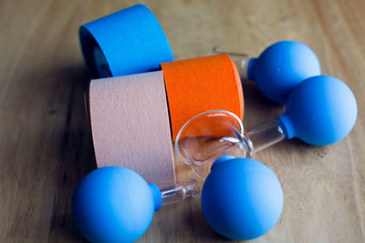 Colored kinesio tapes with medical banks are on a wooden table