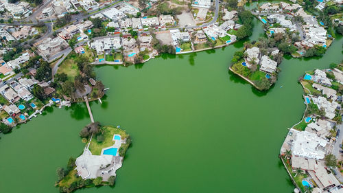 High angle view of buildings by lake in city