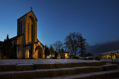 Exterior of building against clear blue sky at dusk