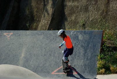 Girl skateboarding on ramp