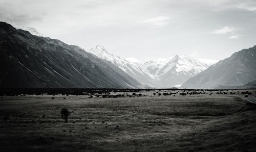 Scenic view of mountains against cloudy sky