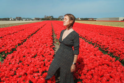 Woman standing on tulip field