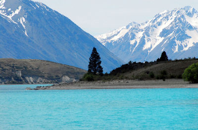 Scenic view of sea and mountains against sky