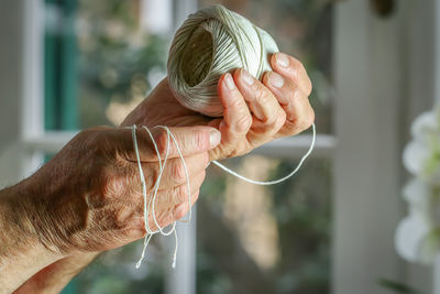 Close-up of man holding hands on table