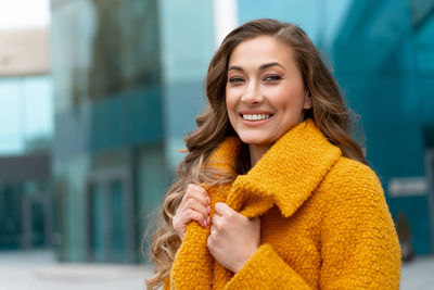 Portrait of smiling woman standing outdoors