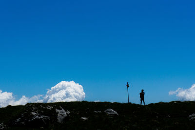 Man photographing against clear blue sky