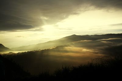 Scenic view of silhouette mountains against sky at sunset