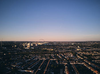 High angle view of illuminated city against sky during sunset