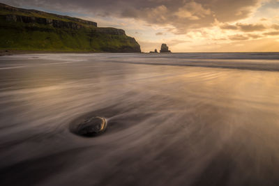 Scenic view of sea against cloudy sky