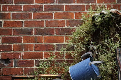 Rear view of man against brick wall