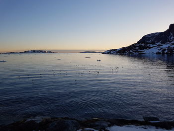 Scenic view of sea against clear sky during sunset