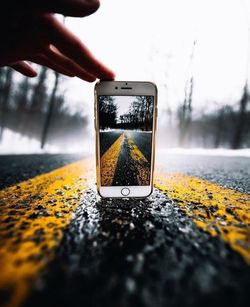 Close-up of hand holding mobile phone