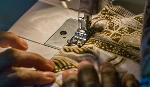 High angle view of man working on fabric