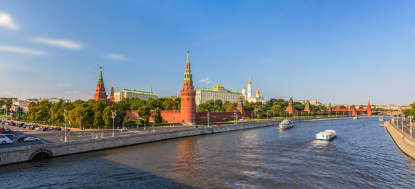 Bridge over river in city against sky