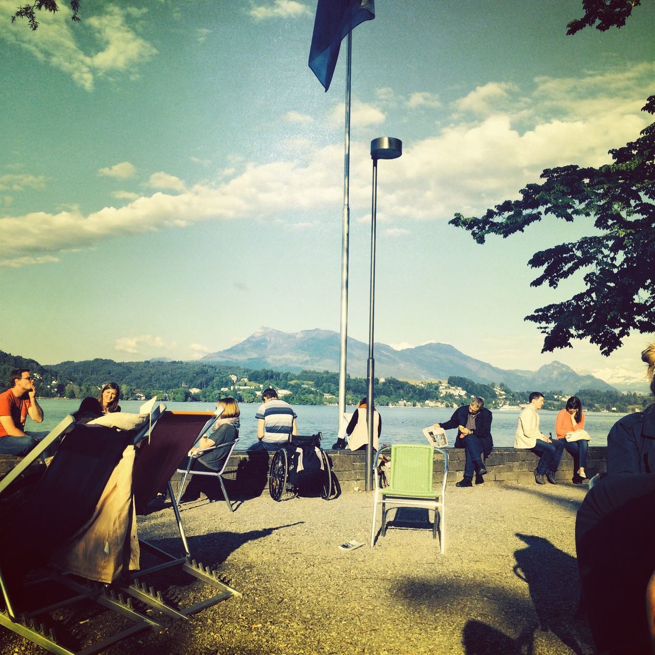 sky, large group of people, relaxation, leisure activity, men, cloud - sky, lifestyles, person, tree, cloud, chair, mountain, vacations, sitting, nature, day, beach, outdoors, scenics