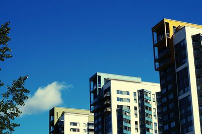 Low angle view of buildings against blue sky