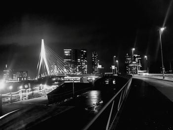 View of suspension bridge in city at night