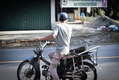 Man riding motorcycle on street