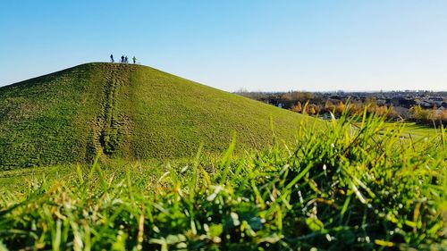 Scenic view of hill against clear sky