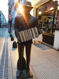 Man holding woman standing on footpath