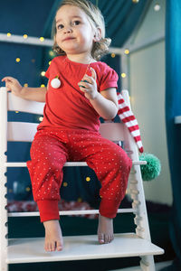 Low angle view of girl sitting on chair