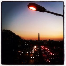 View of illuminated street lights at night