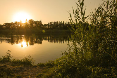 Scenic view of lake against sky during sunset