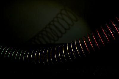 Close-up of spiral staircase against black background