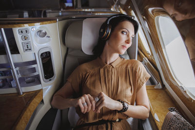 Full length of woman sitting in car