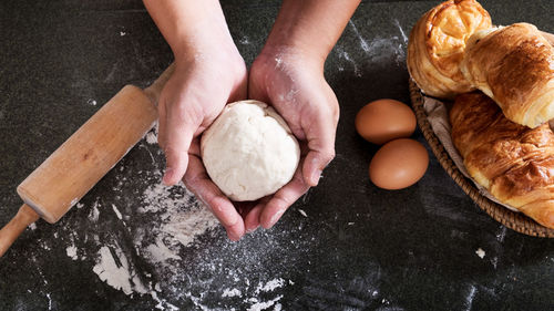 Cropped image of woman holding dough