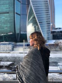 Rear view of woman standing in city