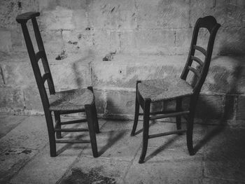 High angle view of chairs on table against wall