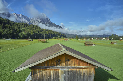 Scenic view of field and mountains against sky