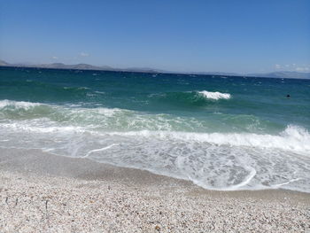 Scenic view of beach against blue sky