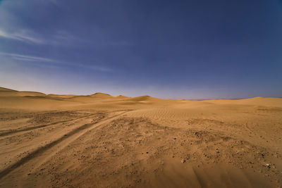 Scenic view of desert against sky during sunset