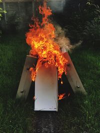 Close-up of bonfire on field at night