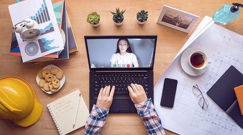 High angle view of man and laptop on table