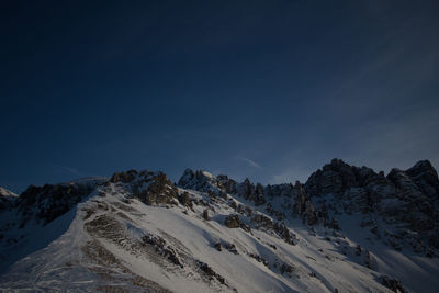 Scenic view of snowcapped mountains against clear blue sky