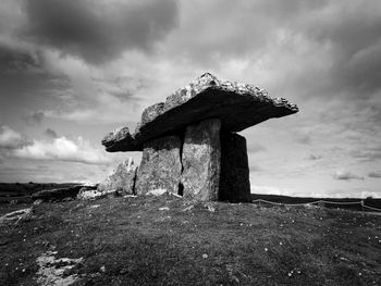 Old castle on land against sky