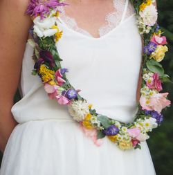 Midsection of woman wearing floral garland