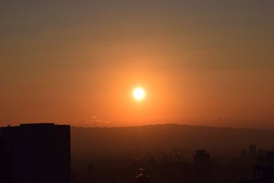 Scenic view of sunset over city