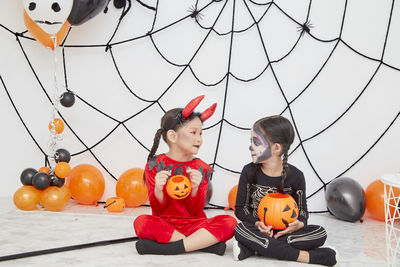 High angle view of girl and vegetables on display during halloween