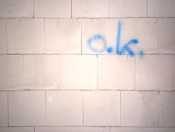 Close-up of text ok written on wall