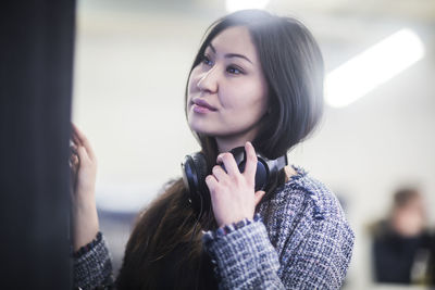 Young asia woman with paper in an office looking