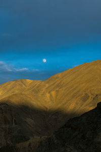 Scenic view of desert against blue sky