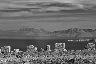 Scenic view of sea and mountains against sky