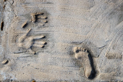 High angle view of footprints on sand at beach