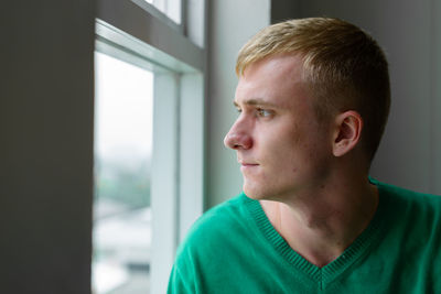 Close-up portrait of teenage boy looking away