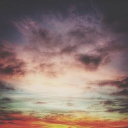 Low angle view of cloudy sky at sunset