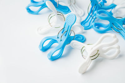 Close-up of clothespins over white background